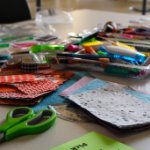 Materials for zine construction: paper, coloring pens and scissors on April 7, 2026